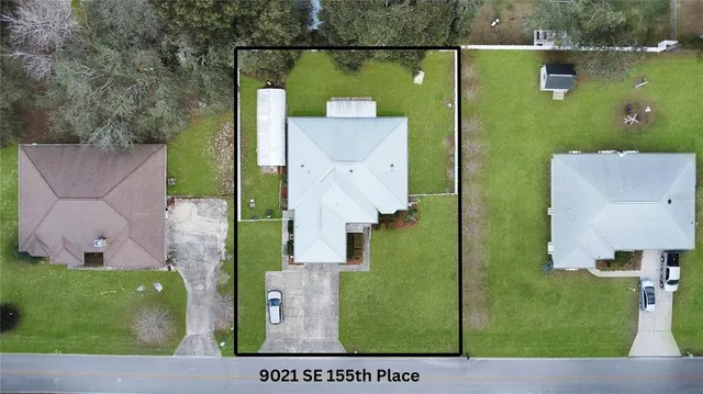 an aerial view of a house with a yard