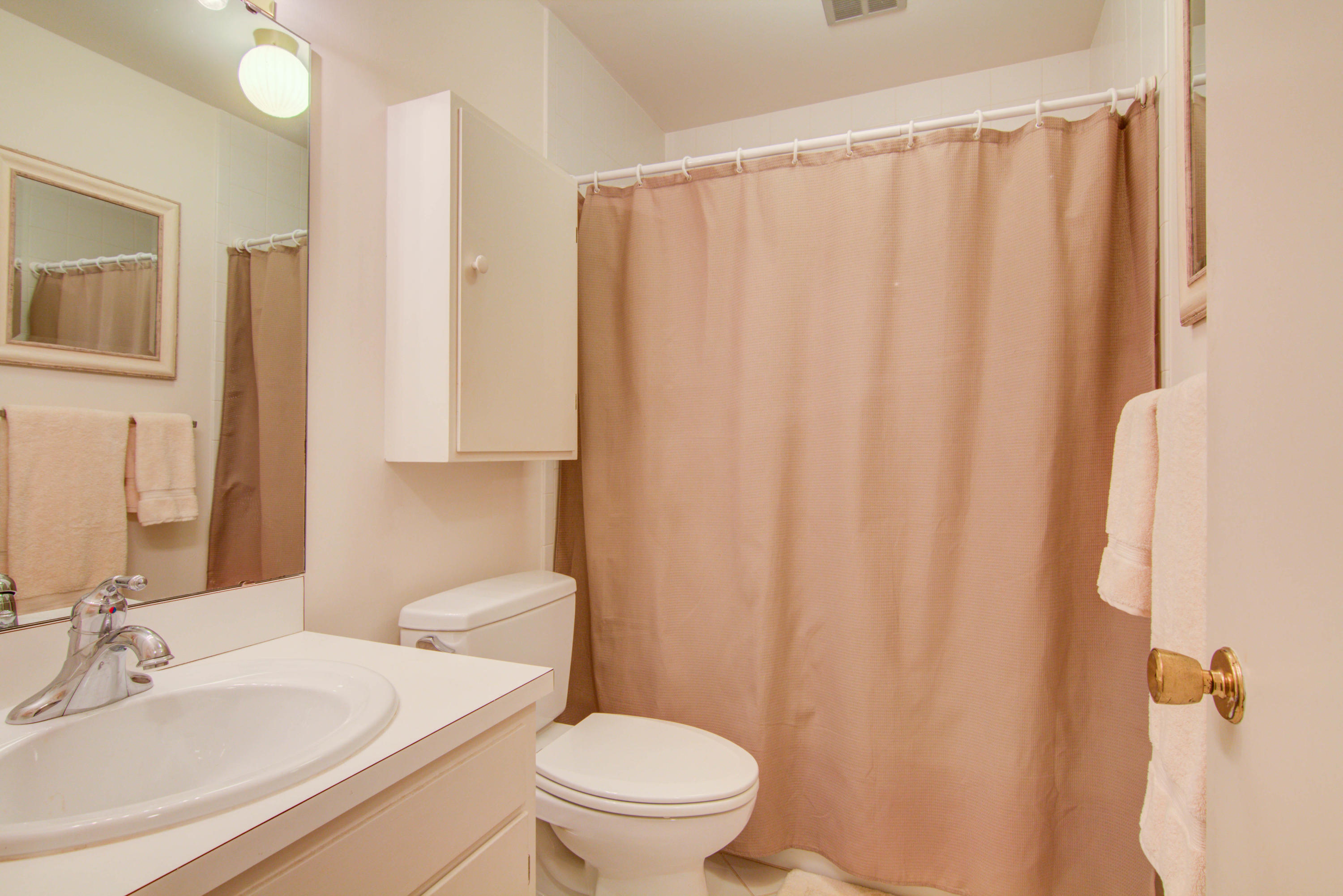 4606 Rosecrest Road Roanoke, VA 24018 - Photo 6 of 28 a bathroom with a sink a toilet and shower curtain