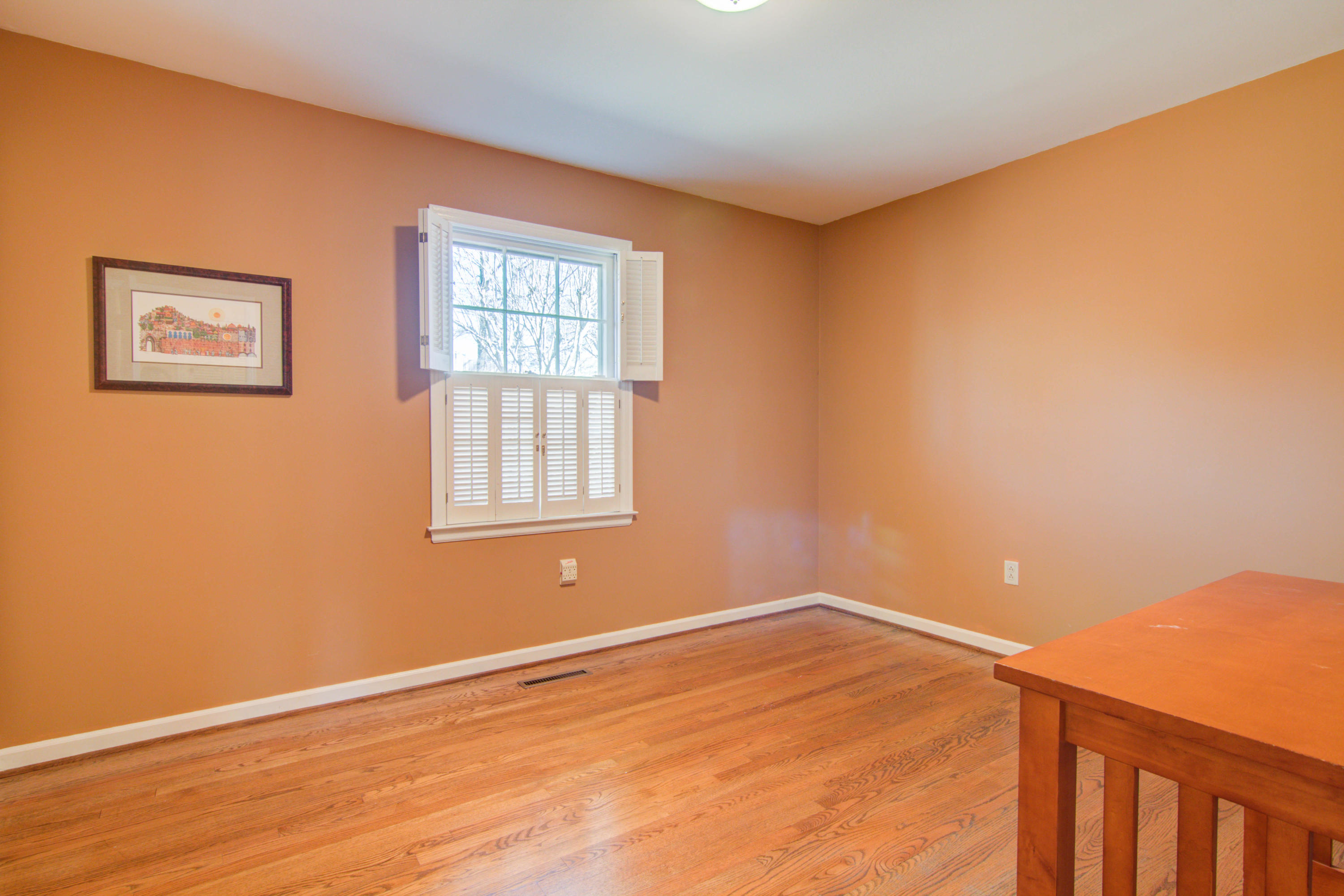 4606 Rosecrest Road Roanoke, VA 24018 - Photo 7 of 28 a view of an empty room with wooden floor and a window