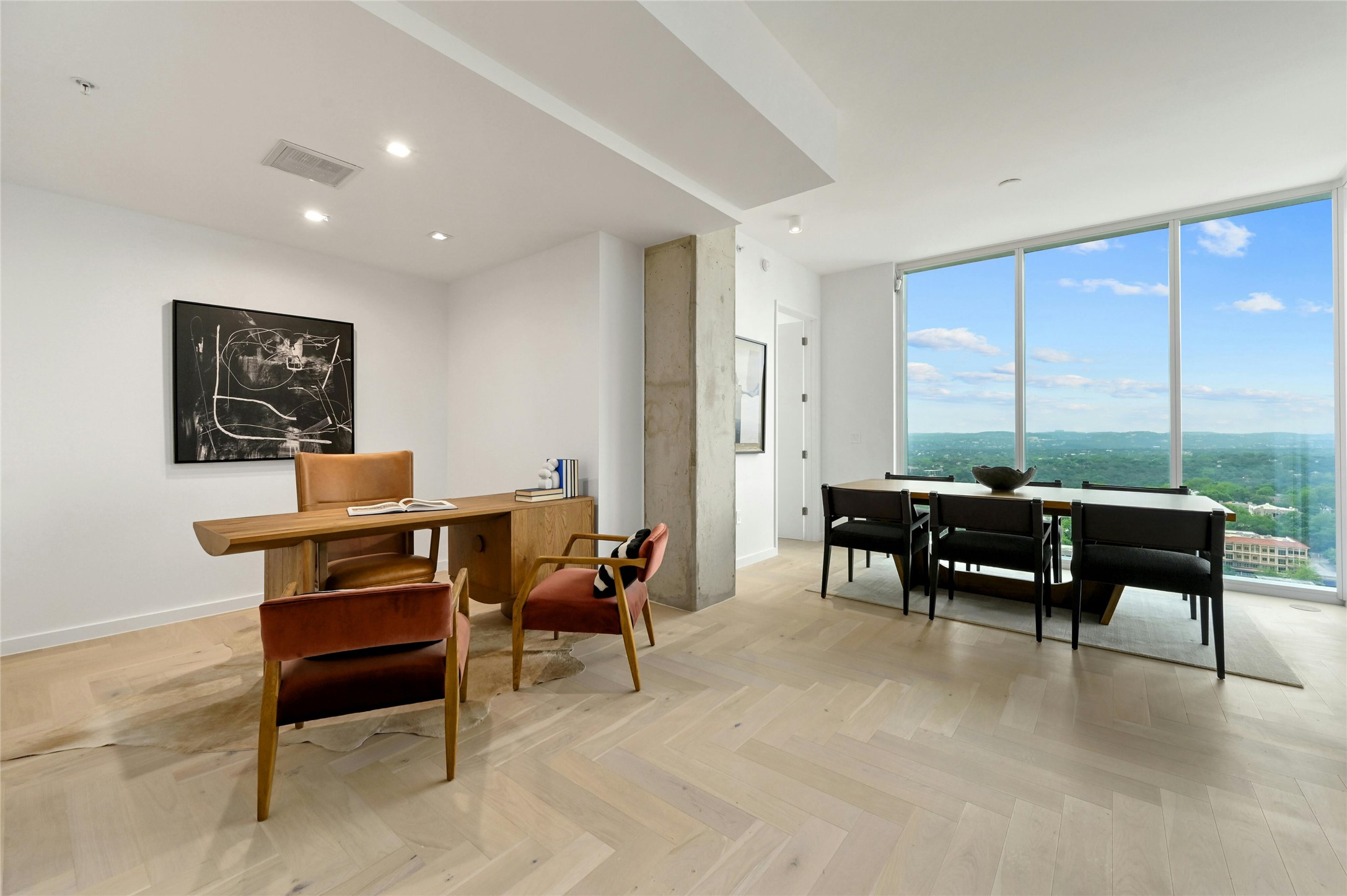 313 West 17th Street, Unit 2204 Austin, TX 78701 - Photo 11 of 40 Designer home office with expansive Hill Country views. The versatile space transitions seamlessly into a dining area bathed in natural light.