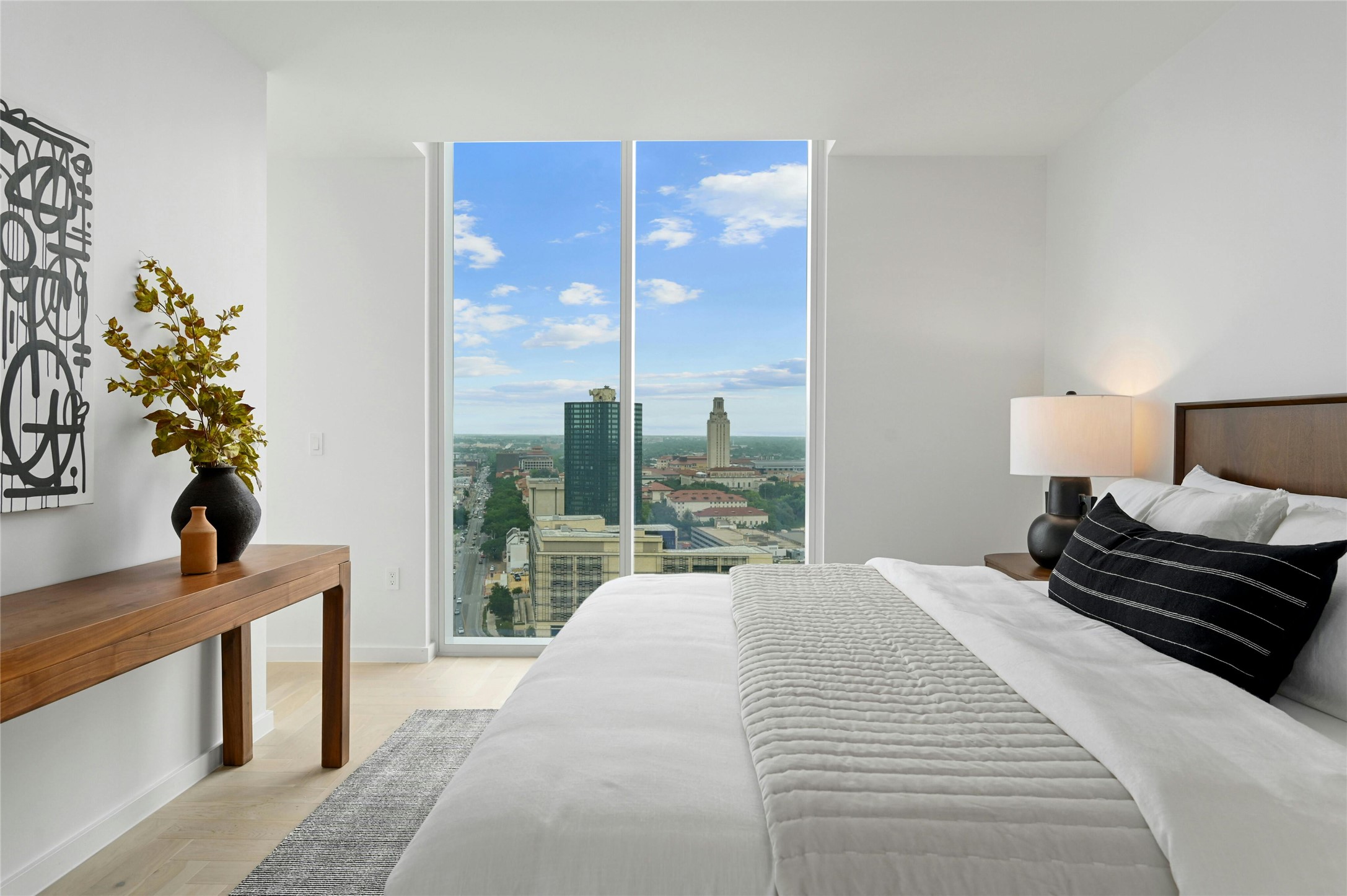 313 West 17th Street, Unit 2204 Austin, TX 78701 - Photo 13 of 40 Step into this sleek and contemporary bedroom featuring floor-to-ceiling windows that frame spectacular views of the city and beyond.
