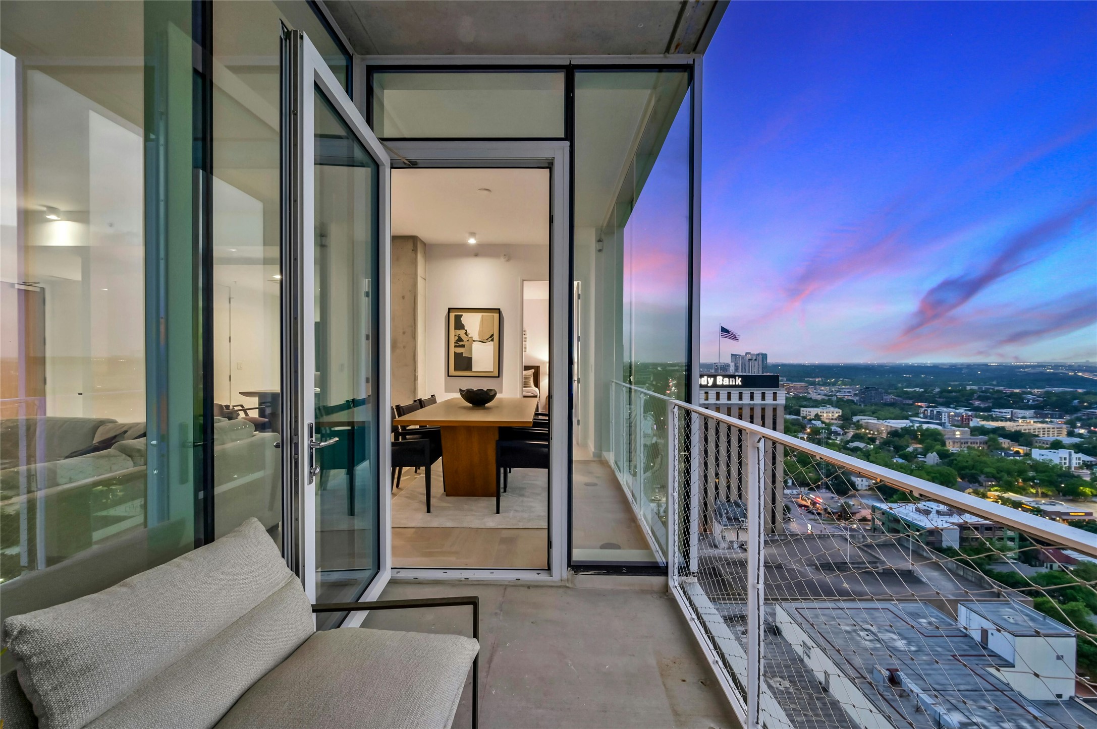 313 West 17th Street, Unit 2204 Austin, TX 78701 - Photo 21 of 40 Private balcony with seamless indoor-outdoor flow, ideal for entertaining or relaxing while taking in sweeping sunset views over the city.
