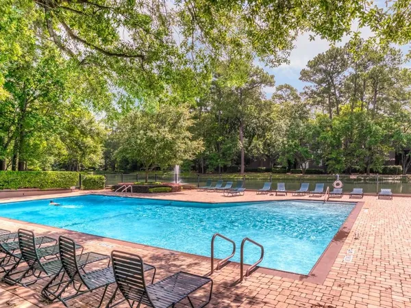 a view of a swimming pool with a lounge chair