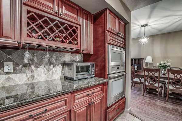 a kitchen with stainless steel appliances granite countertop a stove a sink and a microwave