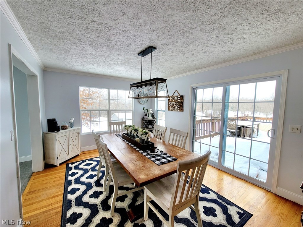6087 Hanna Road Ravenna, OH 44266 - Photo 13 of 34 Nice and bright morning room has a sliding glass door that will lead to the deck. Enjoy wonderful family and friend gatherings here!