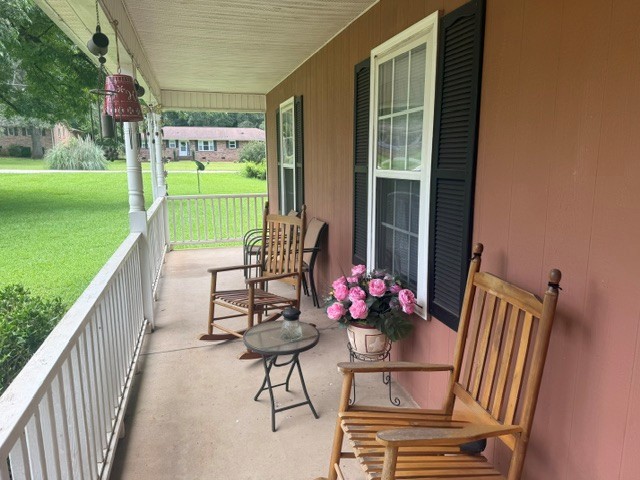 1030 Mc Kinney Street Anderson, SC 29621 - Photo 2 of 6 An inviting front porch with ample space for rocking chairs overlooks the verdant yard.
