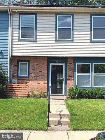a view of a house with a yard and plants