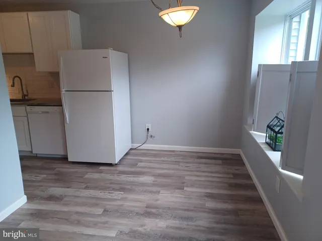 a view of a kitchen with a refrigerator and a stove
