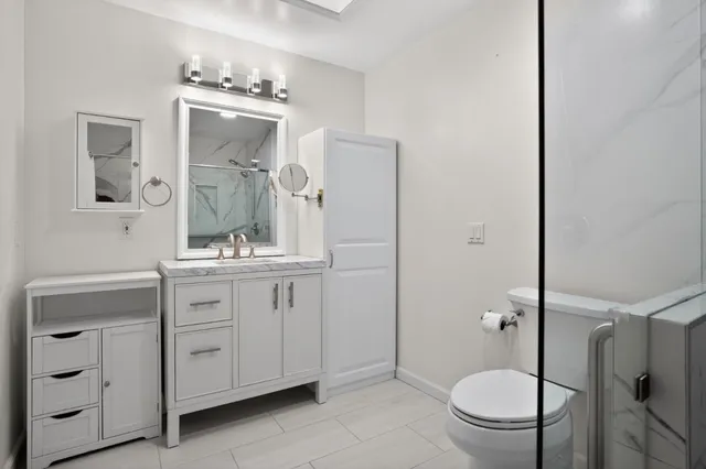 a view of a hallway with a glass door and shower