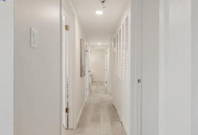 a view of a hallway with wooden floor