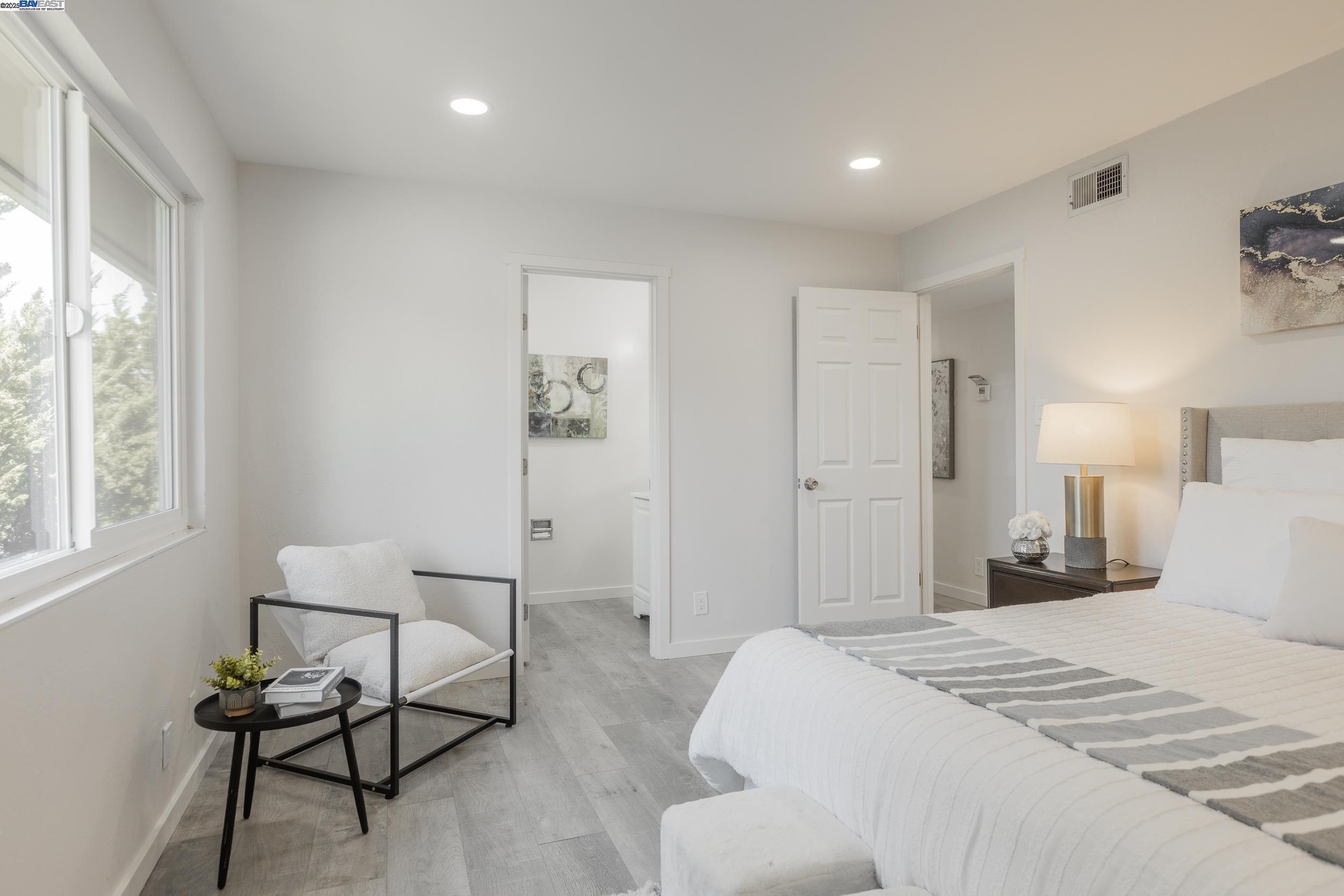 1965 Ascot Drive, Unit 6 Moraga, CA 94556 - Photo 9 of 25 a bedroom with a bed and a chair