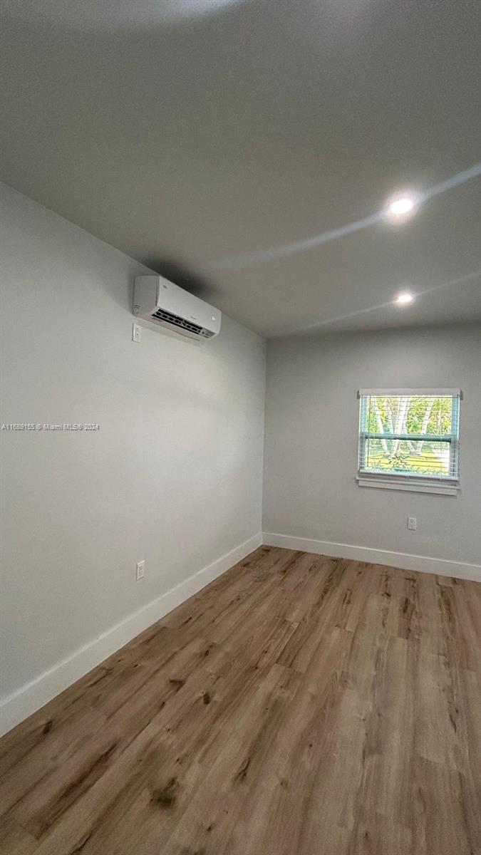 Miami-Dade County Miami, FL 33173 - Photo 2 of 11 an empty room with wooden floor and windows