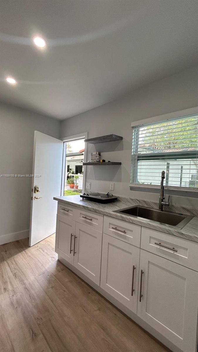 Miami-Dade County Miami, FL 33173 - Photo 8 of 11 a kitchen with white cabinets and sink