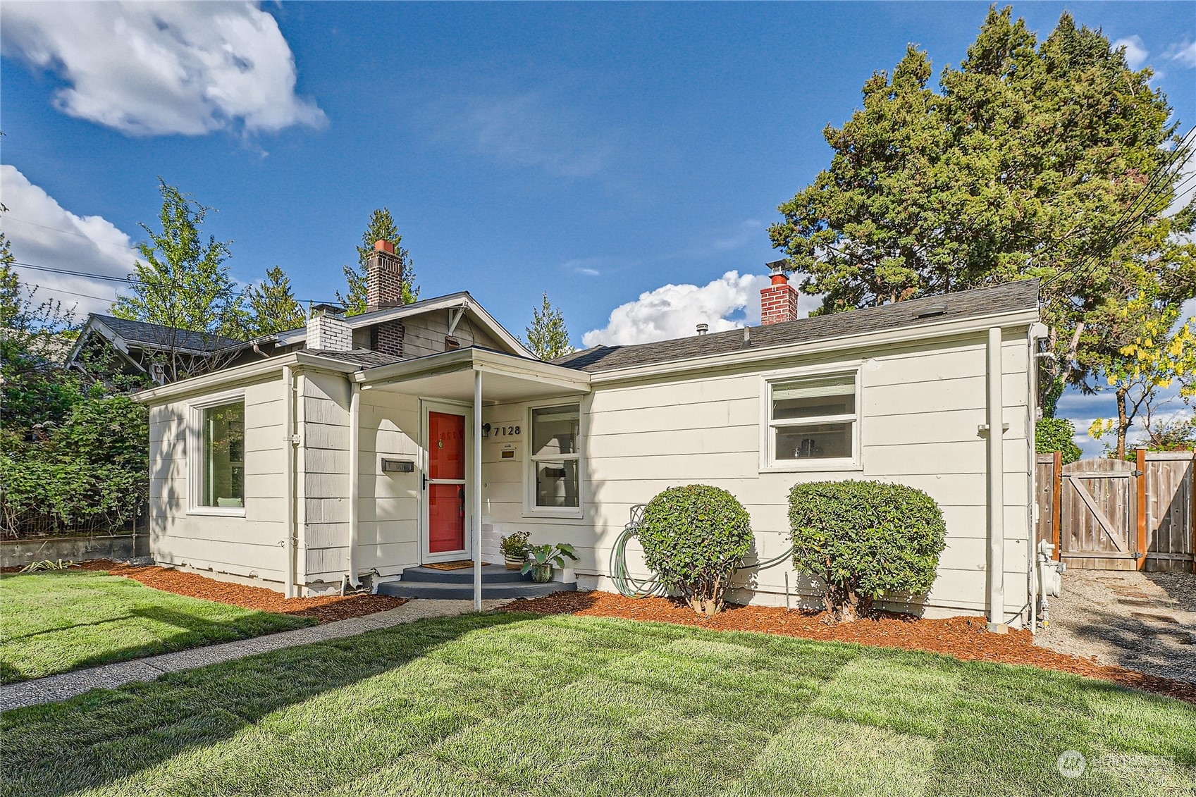 7128 Seward Park Avenue South Seattle, WA 98118 - Photo 1 of 25 a view of a house with yard and a garden