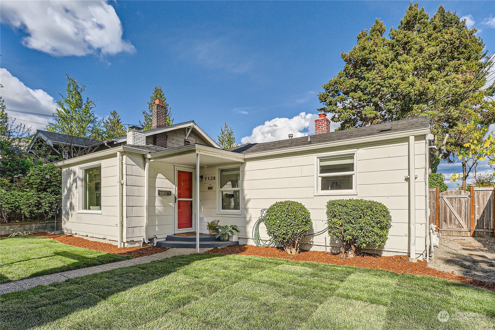 a view of a house with yard and a garden