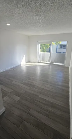 a view of wooden floor and windows in a room