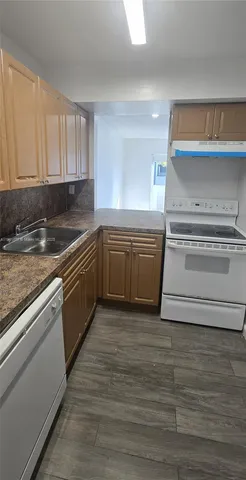 a kitchen with granite countertop a sink and cabinets