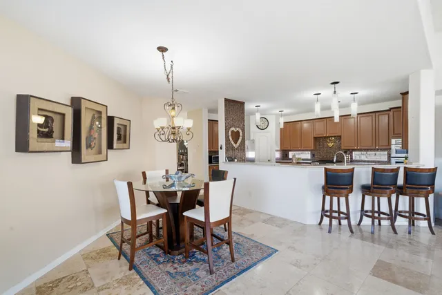 a dining room with furniture a rug and a painting