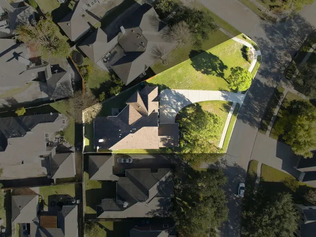 an aerial view of residential house with outdoor space and swimming pool