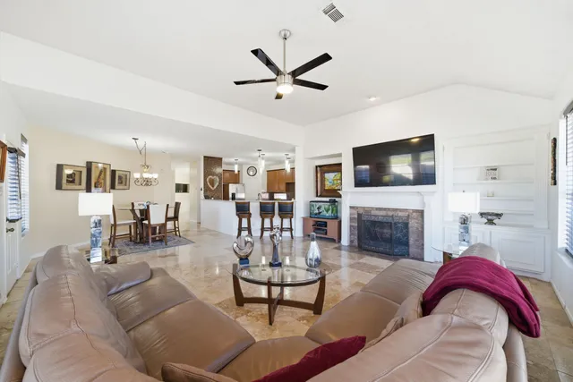 a living room with furniture fireplace and flat screen tv