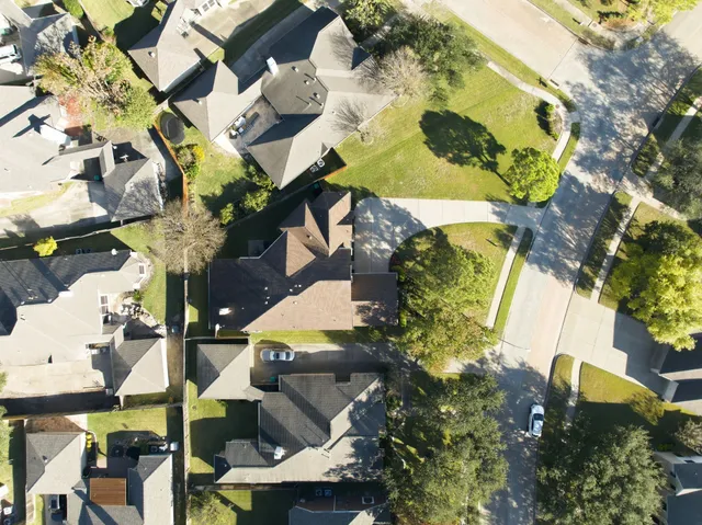 an aerial view of a house with a yard and garden