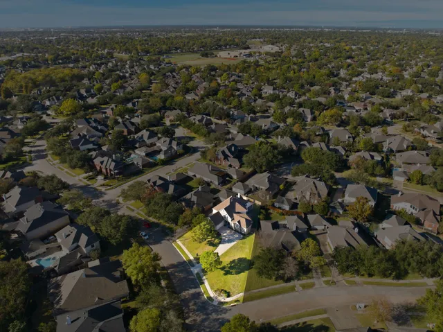 an aerial view of residential houses with outdoor space