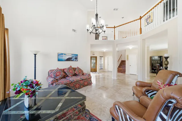 a living room with furniture chandelier and a chandelier