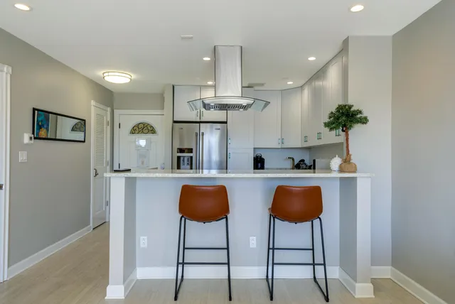a living room with furniture flat screen tv and a large window
