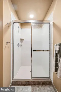 a bathroom with a glass shower door