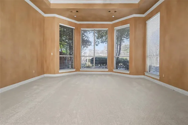 a view of an empty room with a window and balcony view
