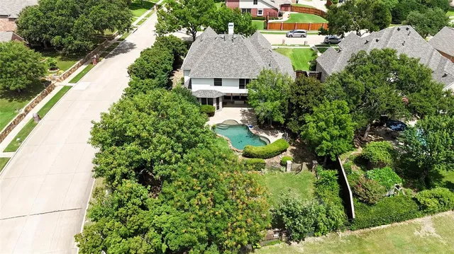 an aerial view of a houses with yard