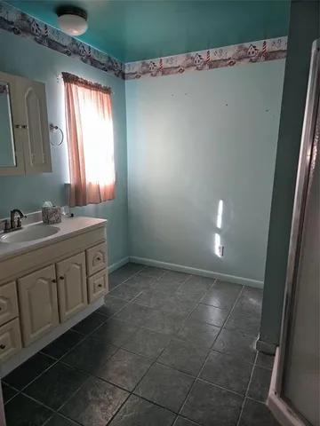 a bathroom with a sink vanity and a mirror