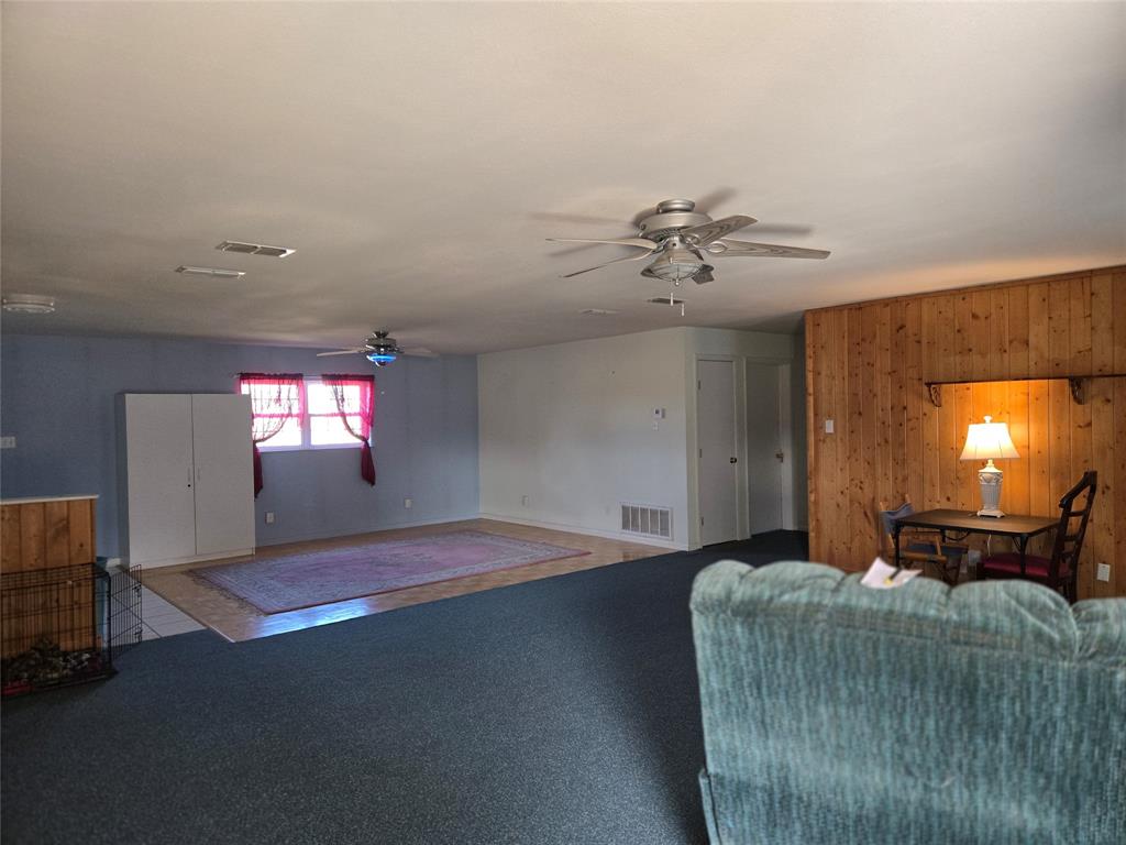 700 County Road 408 Comanche, TX 76442 - Photo 7 of 22 a bedroom with a bed and a chandelier