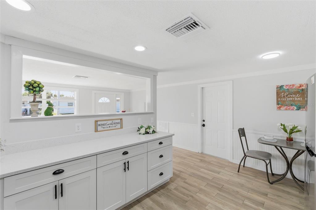 9033 Pegasus Avenue Port Richey, FL 34668 - Photo 12 of 56 a spacious bathroom with a granite countertop sink a mirror and a window