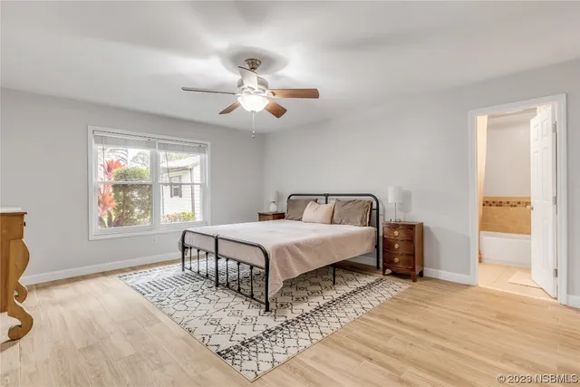 a spacious bedroom with a large bed and a window