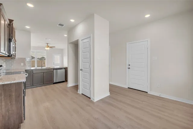 a view of a kitchen with a sink and a refrigerator