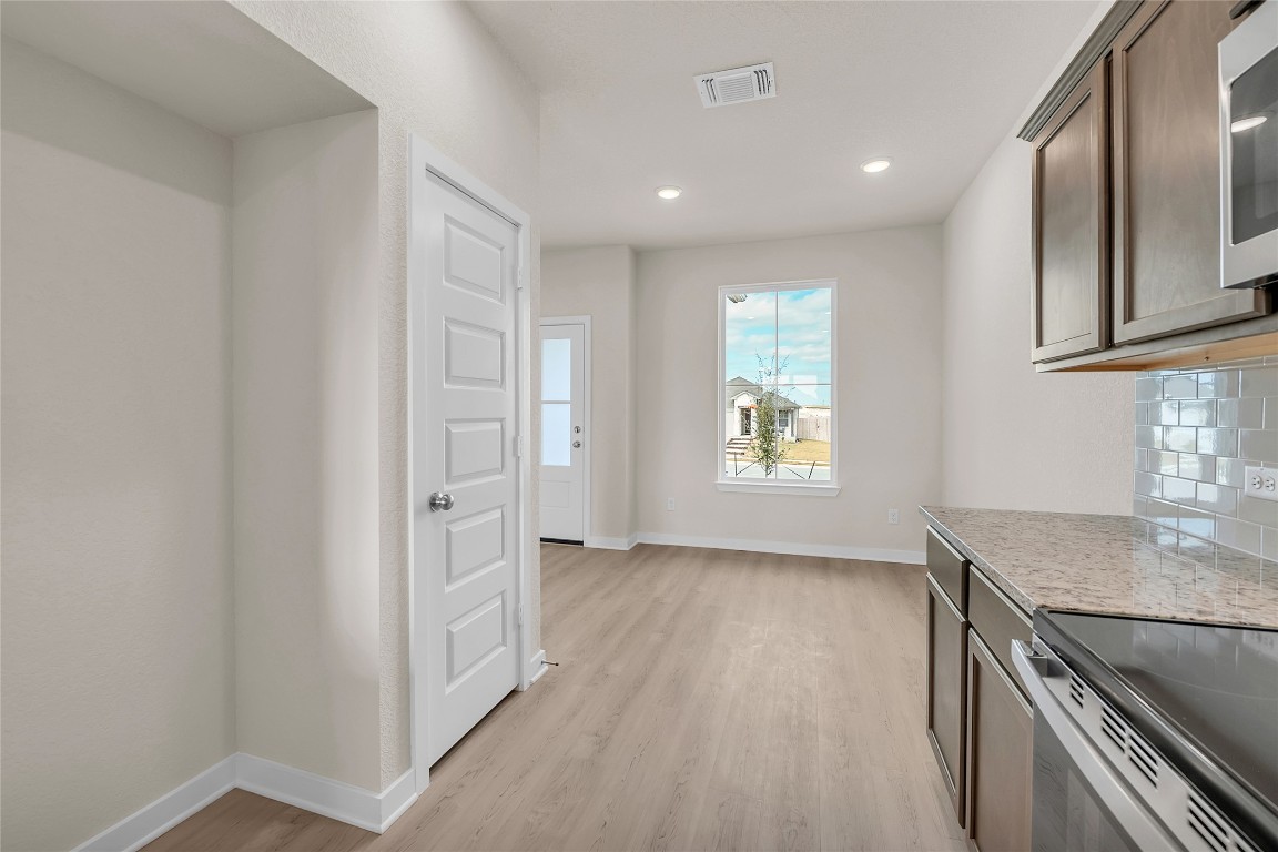 290 Boatright Boulevard Jarrell, TX 76537 - Photo 18 of 32 an empty room with wooden floor and a window