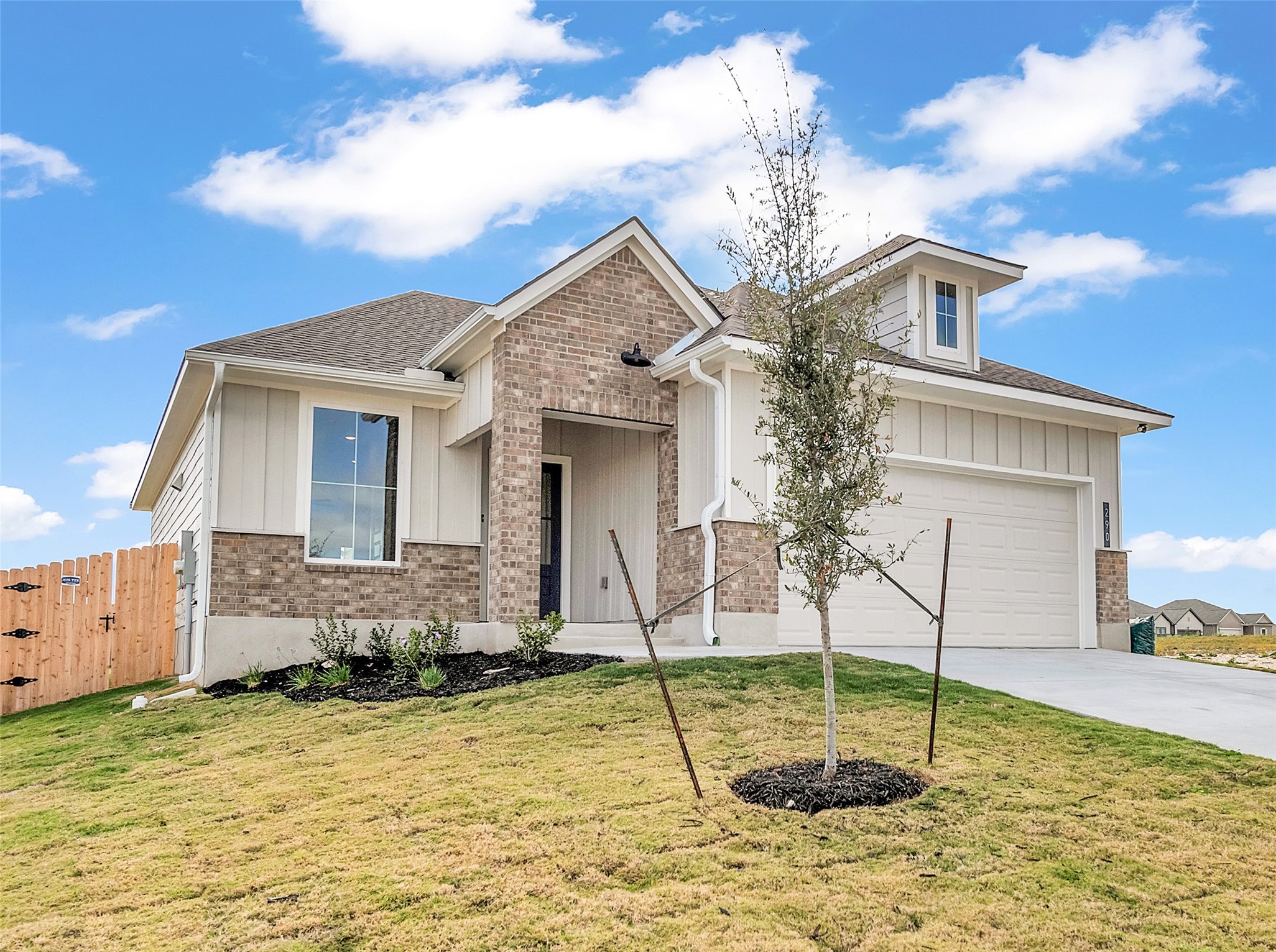 290 Boatright Boulevard Jarrell, TX 76537 - Photo 2 of 32 View of front facade featuring brick siding, driveway, board and batten siding, and a shingled roof