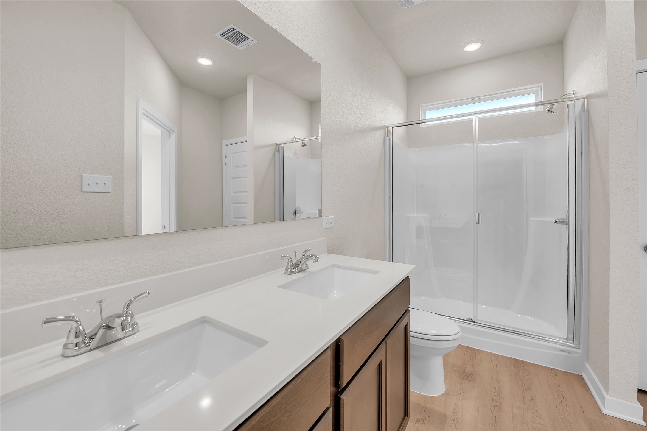 290 Boatright Boulevard Jarrell, TX 76537 - Photo 27 of 32 Full bathroom featuring double vanity, a stall shower, and light wood finished floors