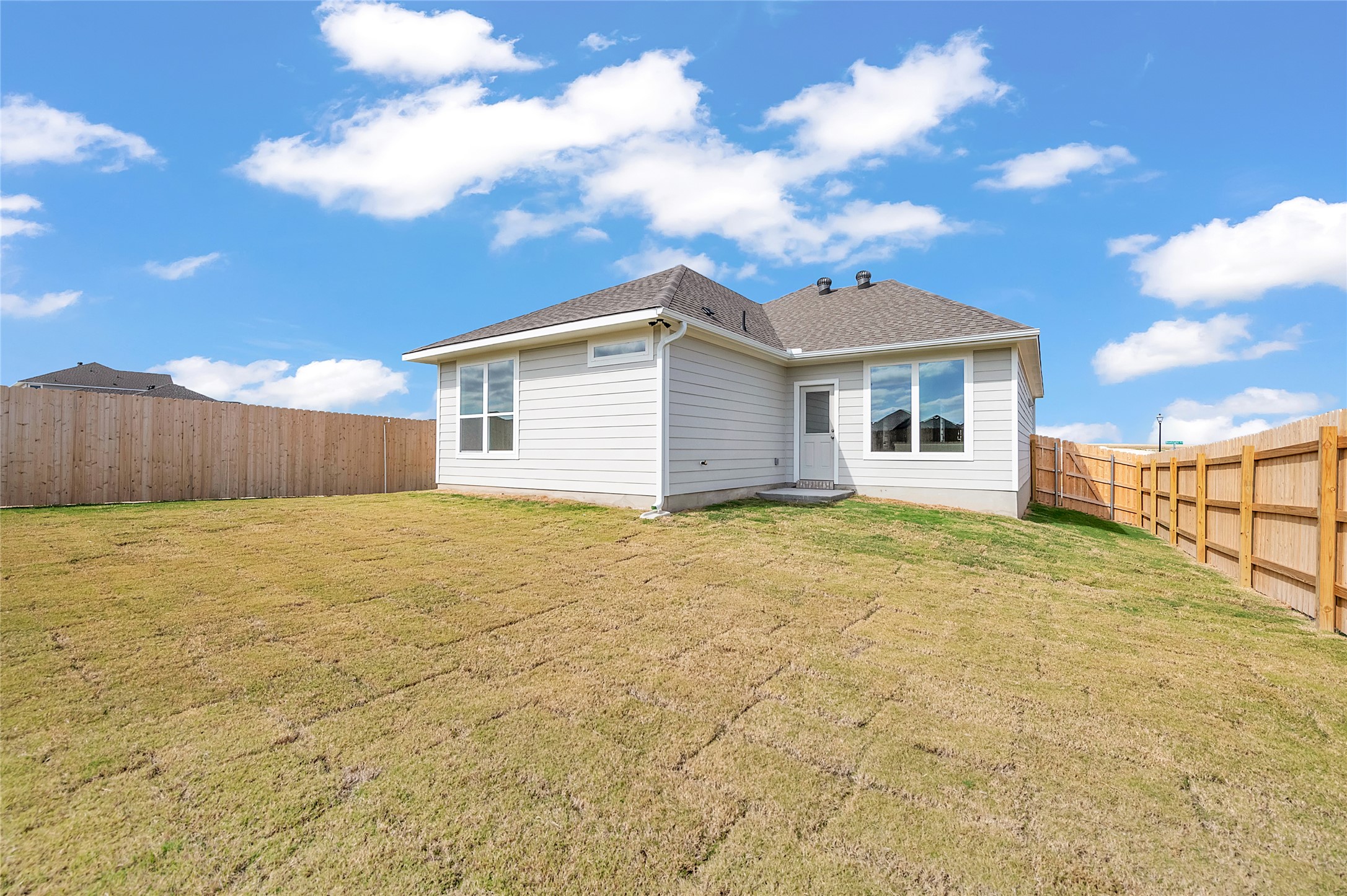 290 Boatright Boulevard Jarrell, TX 76537 - Photo 31 of 32 Rear view of property featuring a fenced backyard and a shingled roof