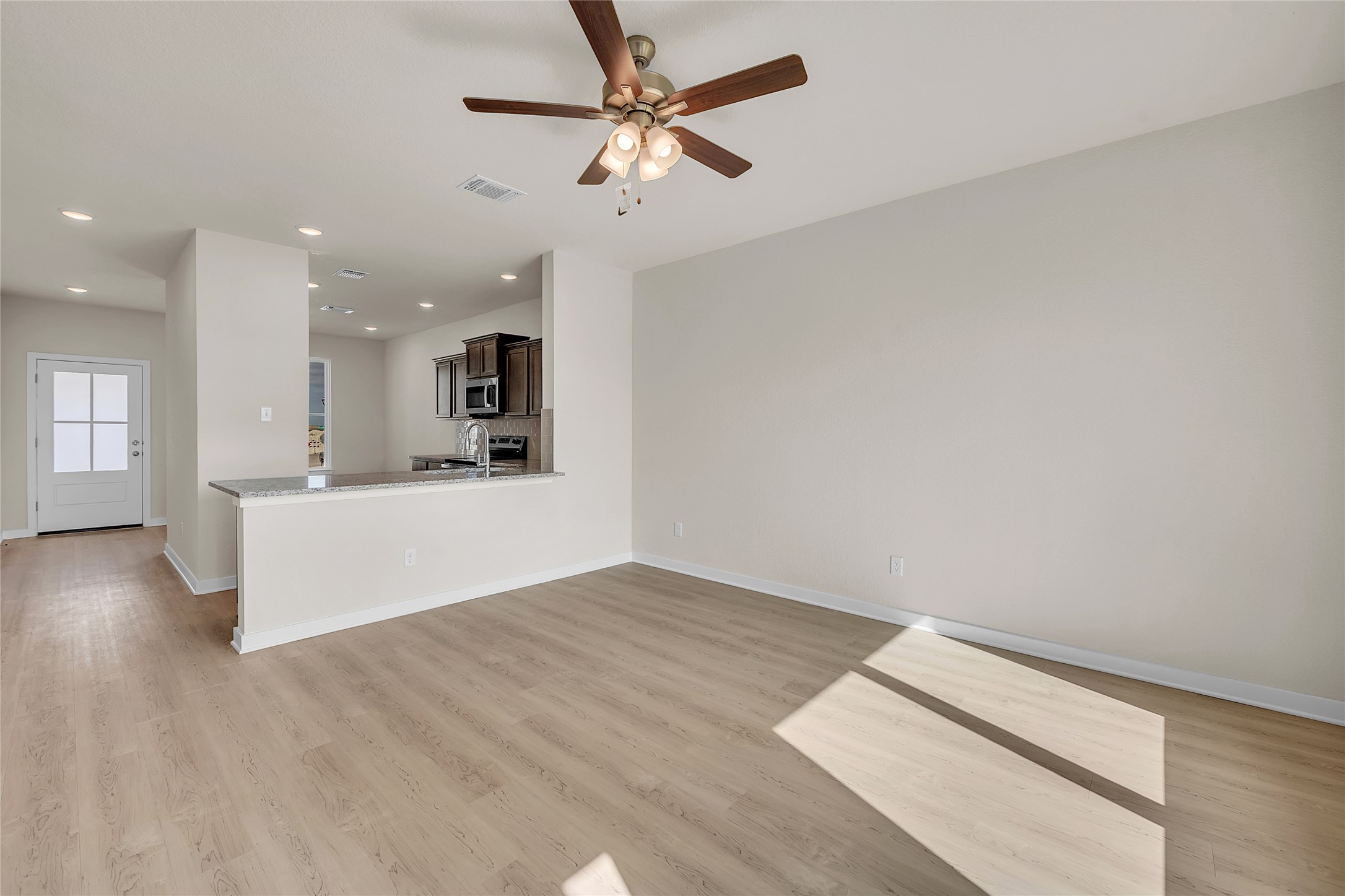 290 Boatright Boulevard Jarrell, TX 76537 - Photo 6 of 32 Unfurnished living room featuring recessed lighting, light wood finished floors, and a ceiling fan