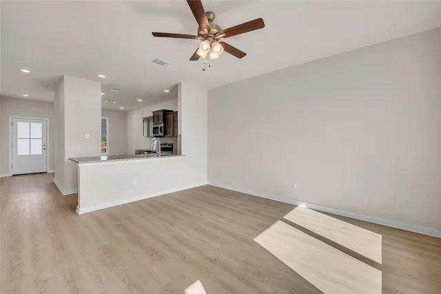 a view of a kitchen with a sink and a chandelier fan