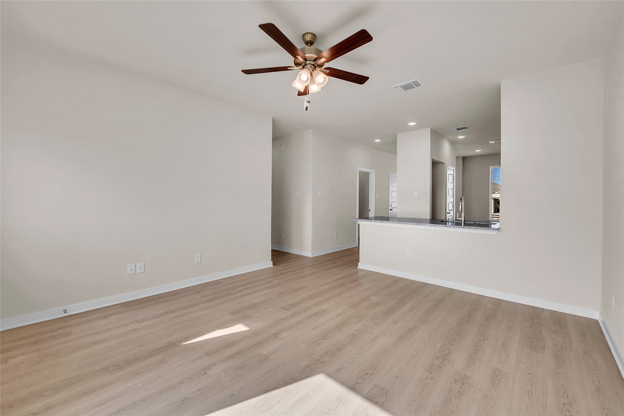 290 Boatright Boulevard Jarrell, TX 76537 - Photo 8 of 32 Unfurnished living room with recessed lighting, a ceiling fan, and light wood-style flooring