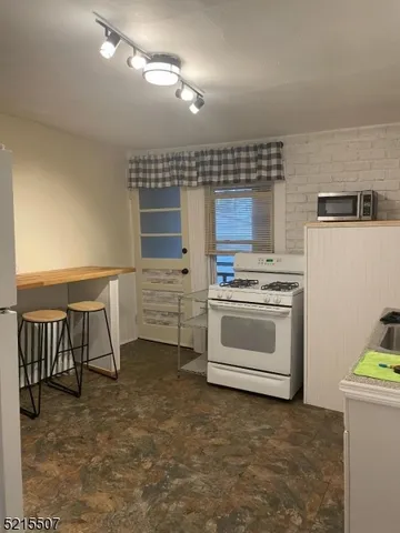 a kitchen with a stove a sink and a refrigerator