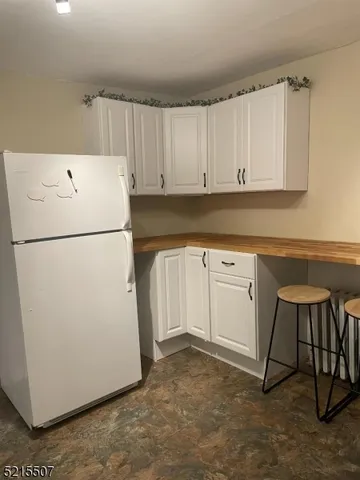 a white refrigerator freezer sitting in a kitchen