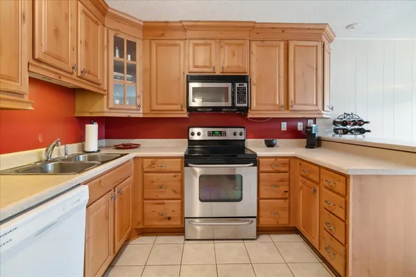 a kitchen with a sink stove and microwave