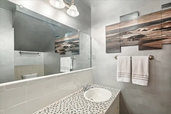 a bathroom with a sink a vanity and mirror