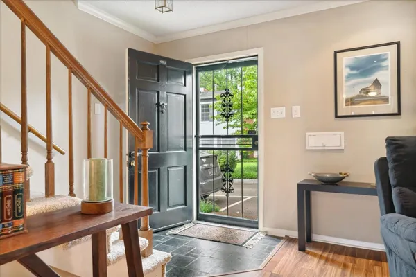 a view of an entryway with wooden floor and windows