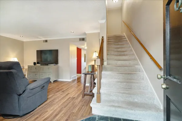 a living room with couches and a flat screen tv