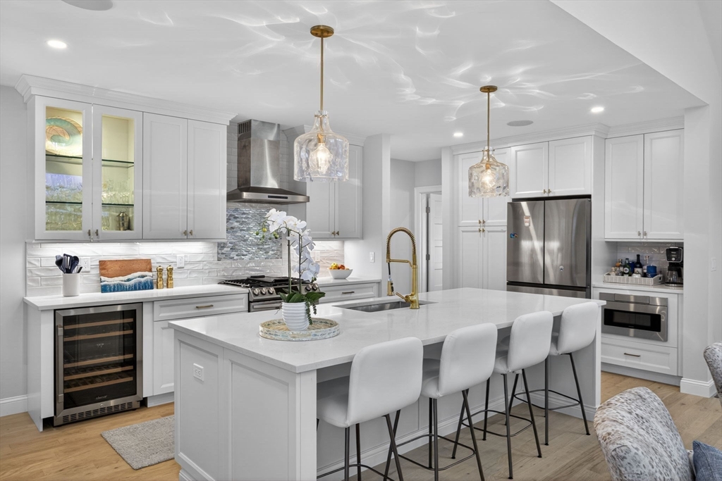 42 Cobblestone Circle Mashpee, MA 02649 - Photo 11 of 40 a kitchen with stainless steel appliances kitchen island granite countertop a sink and refrigerator